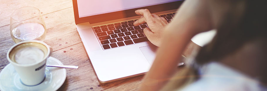 On a computer with coffee