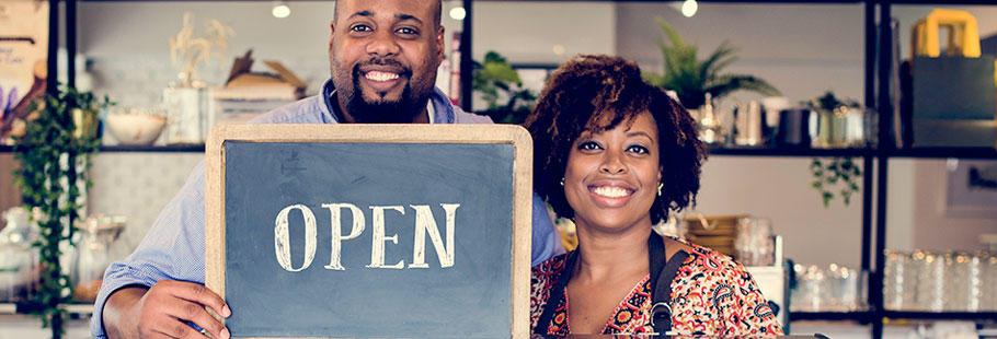 People holding an open sign