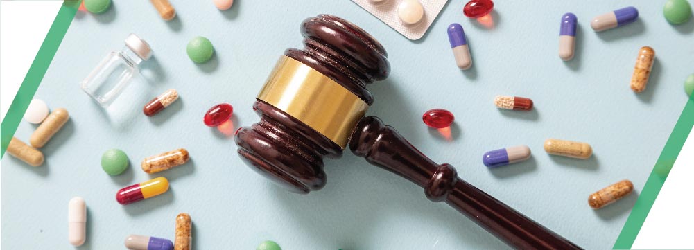 Pills and medication with gavel.