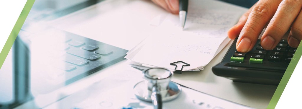 Person working with calculator and receipts. 