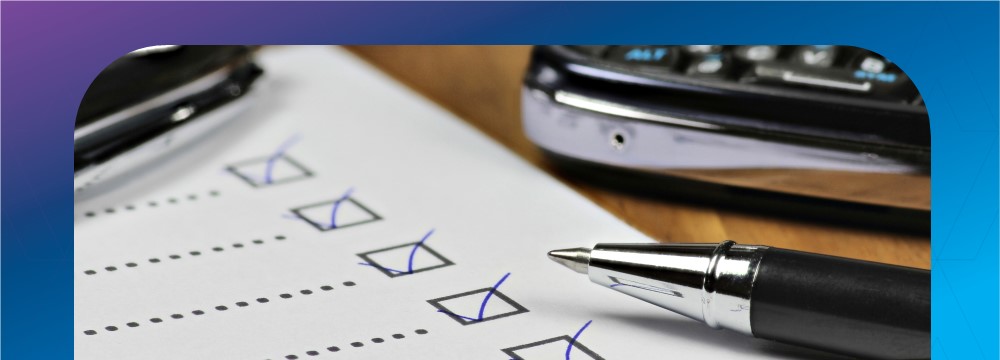 Close-up of a checklist with several boxes checked, next to a pen and smartphone.